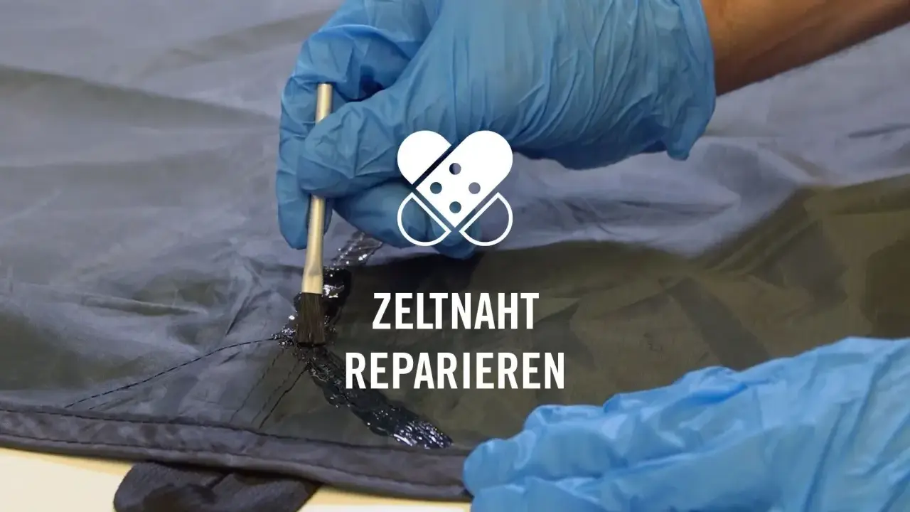 Mit einem Pinsel wird eine dunkle Dichtungsmasse auf eine Zeltnaht aufgetragen, um sie abzudichten und zu reparieren.