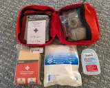 Erste Hilfe Set für das Wandern: Notfalldecke, Kühlpacks, Blasenpflaster und ein Erste-Hilfe-Kit von Forclaz.
