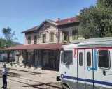 Ein Zug nach Split steht am Bahnhof Perković. Ein Schaffner wartet auf dem Bahnsteig.