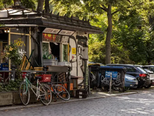 Ein Kiosk in Berlin Kreuzberg mit Fahrrädern davor und Autos dahinter.